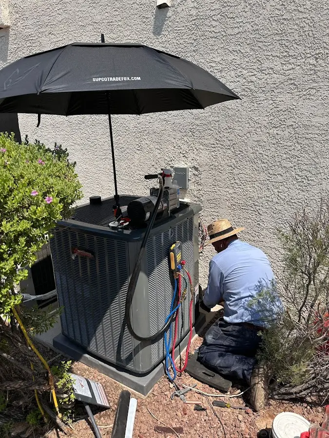 HVAC technician performing outdoor AC maintenance in Mobile